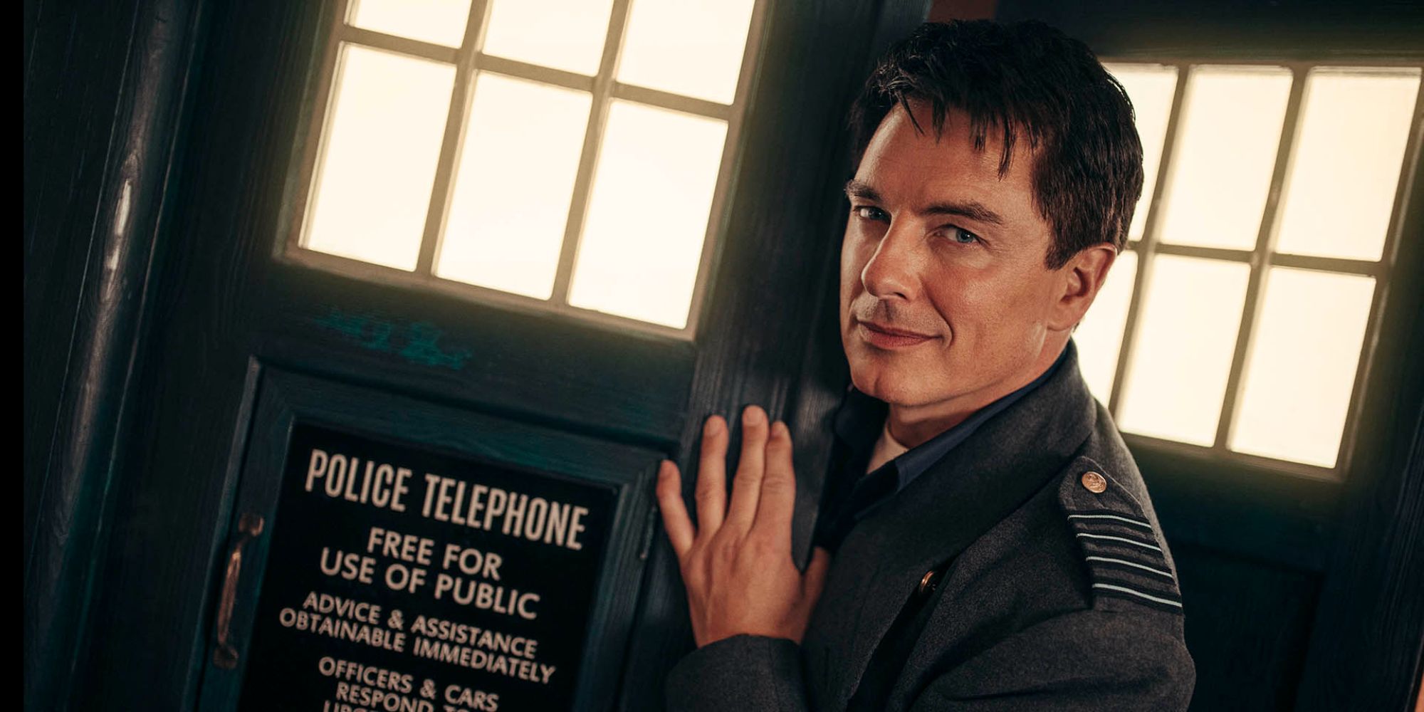 Actor John Barrowman as Captain Jack Harkness in front of the TARDIS door