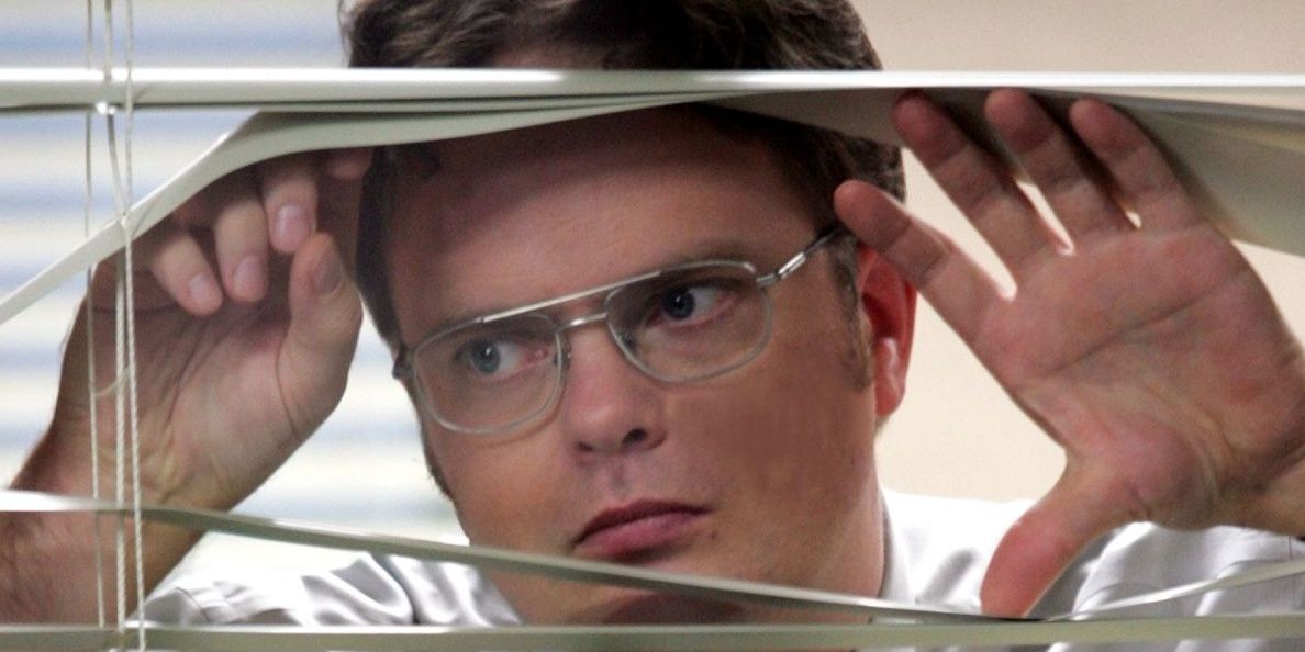 The Office: Dwight Schrute peeking out through the window of his workspace. 