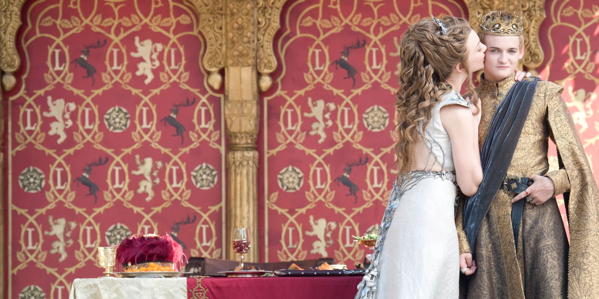 Margaery Tyrell kissing Joffrey Baratheon at their wedding in Game of Thrones