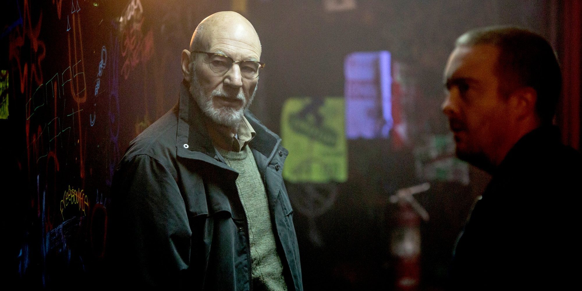 Darcy (Patrick Stewart) hangs around a seedy, graffiti-covered area in 'Green Room'.