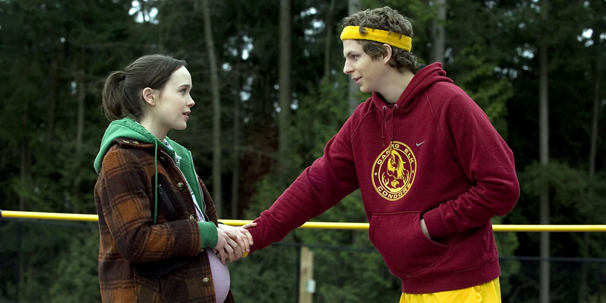 Elliot Page and Michael Cera as Juno and Paulie, as Juno presses Paulie's hand against her stomach in Juno