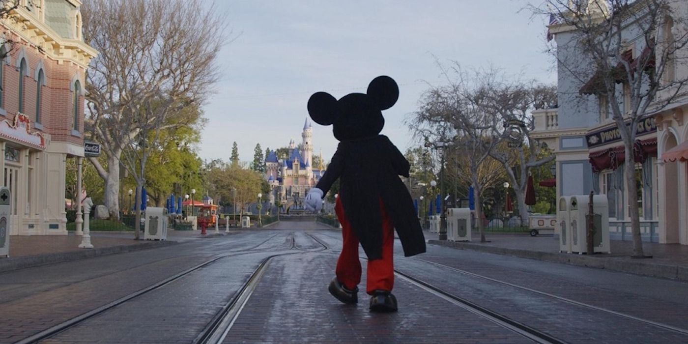 mickey mouse walking towards the Disney castle