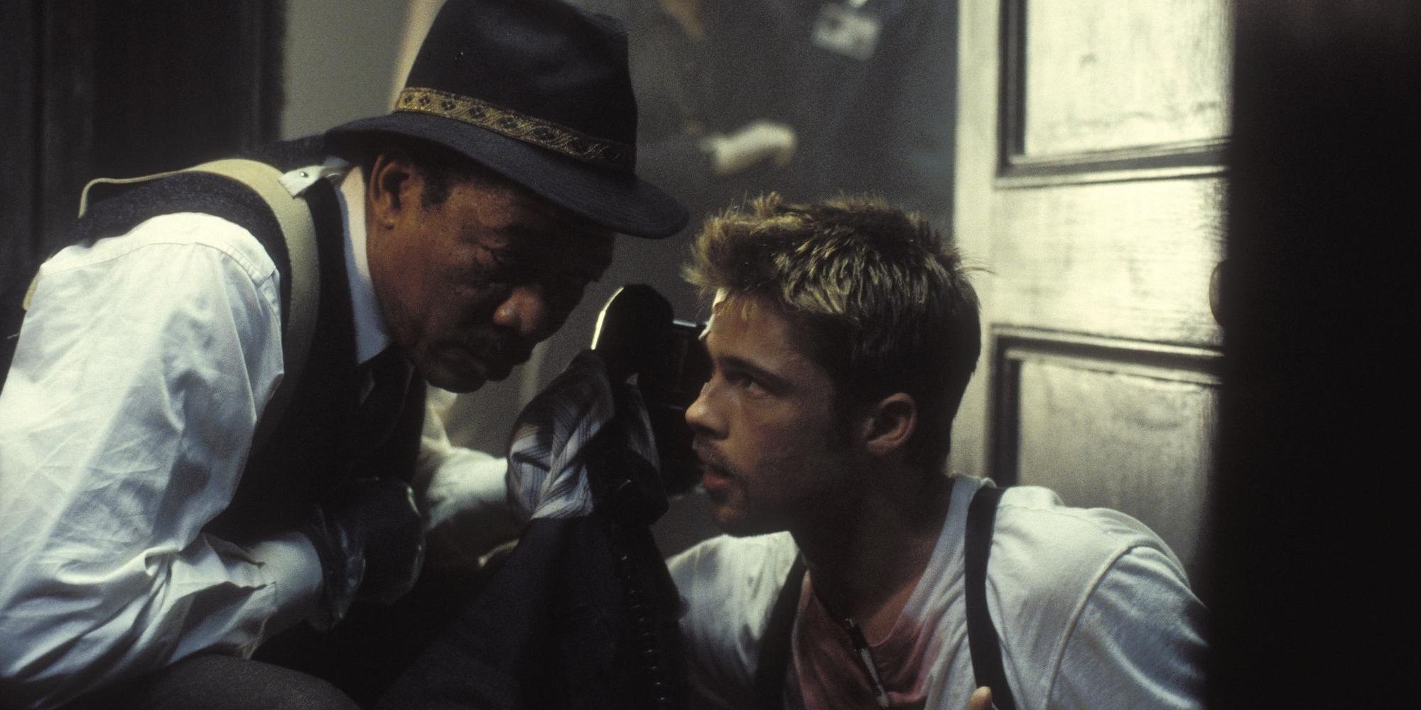 Detectives Somerset (Morgan Freeman) and Mills (Brad Pitt) listening to a phone in Se7en