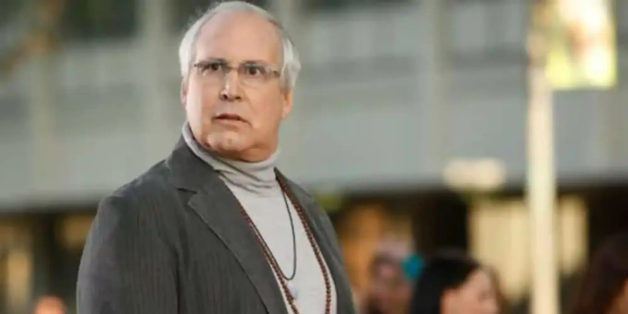 Chevy Chase looks quizically off camera