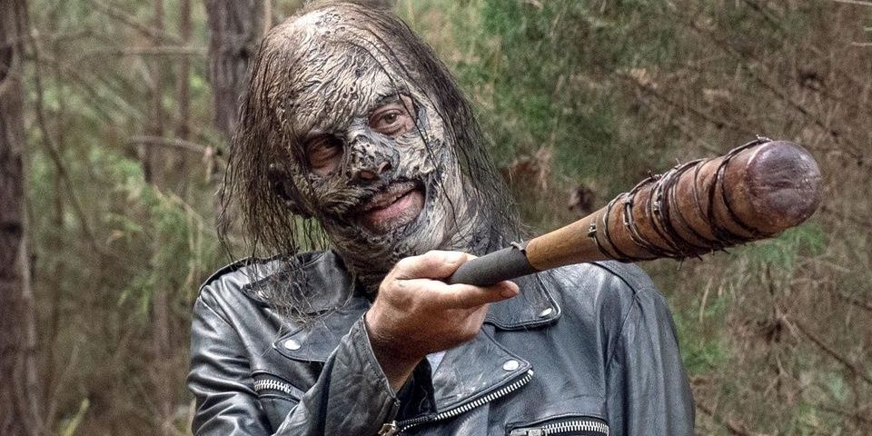 Negan wields Lucille while wearing zombie skin as a mask to blend in with the Whisperers in 'The Walking Dead'