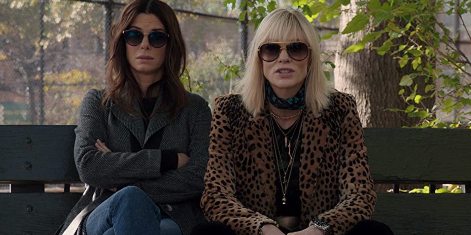 Sandra Bullock and Cate Blanchett sitting on a bench in the 'Ocean's Eight'