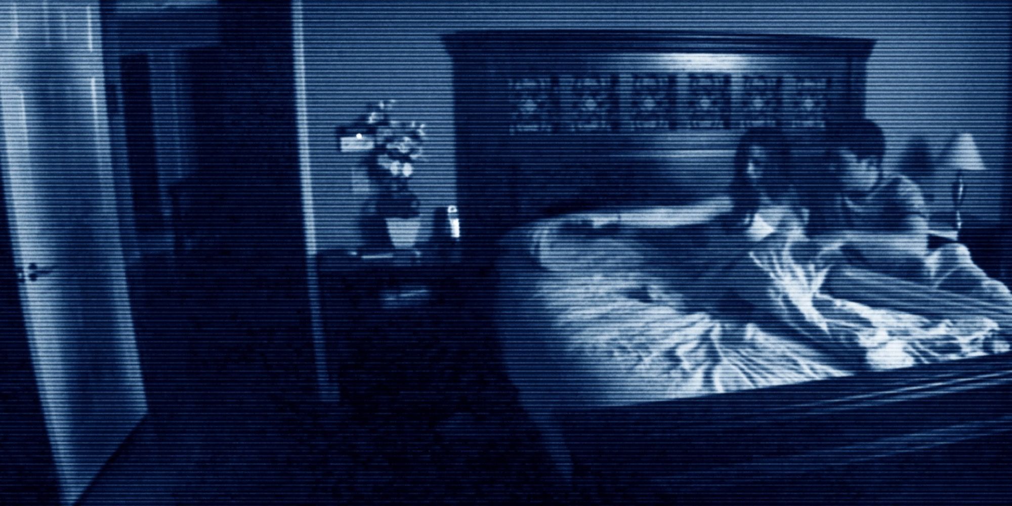 A couple in bed scared by something not visible