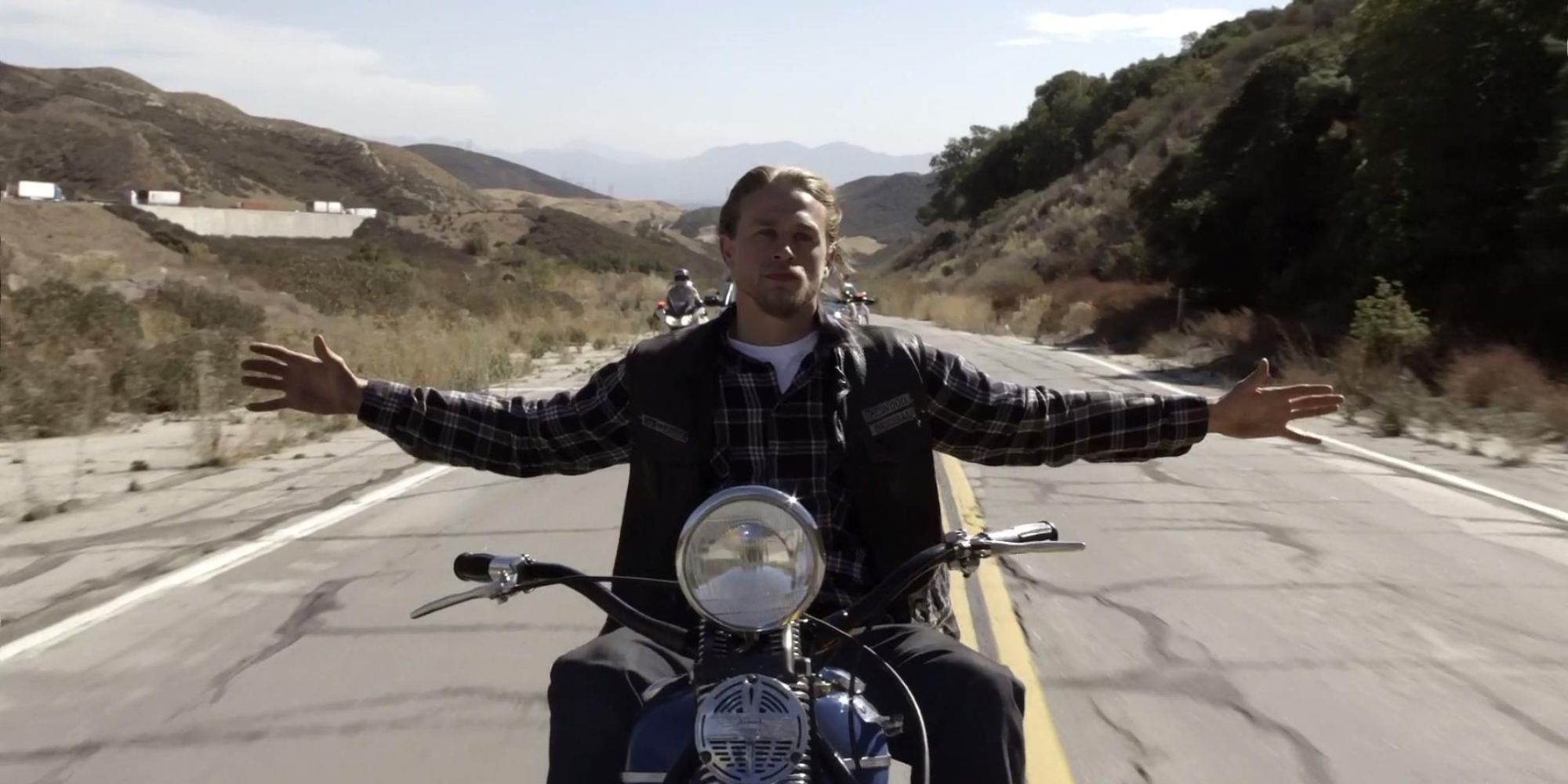 Jax Teller (Charlie Hunnam) riding his motorcycle with his arms spread out just before his death in Sons of Anarchy