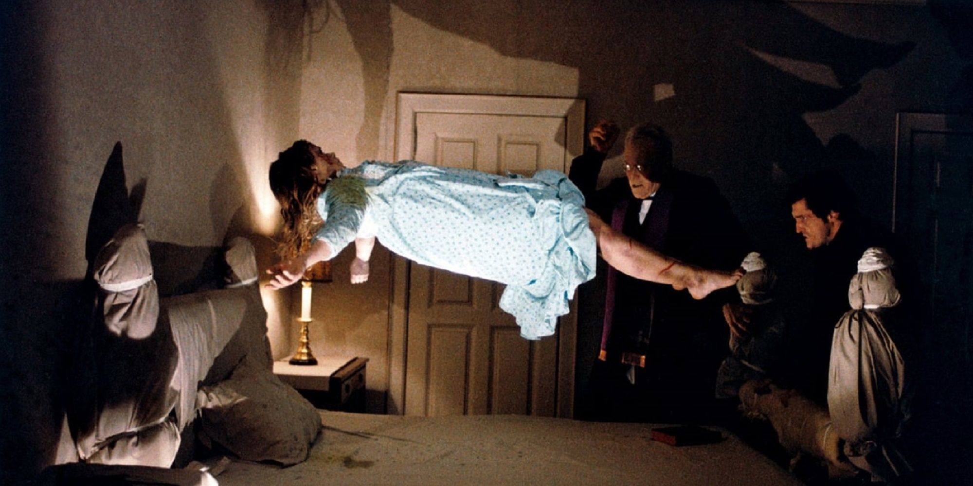 The Exorcist - Regan floating over bed while two priest watches