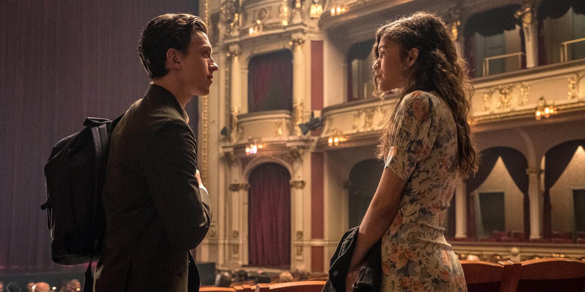 Peter Parker and MJ  standing and facing each other in the aisle of theatre before the start of an opera in Spider-Man: Far From Home 