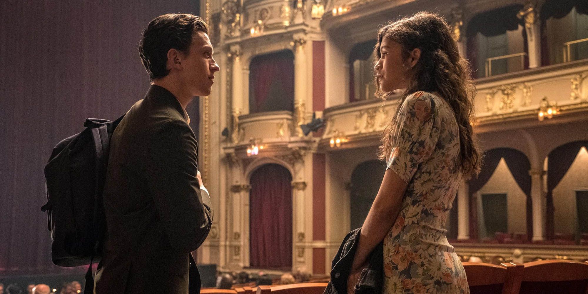 Peter Parker and MJ  standing and facing each other in the aisle of theatre before the start of an opera in Spider-Man: Far From Home