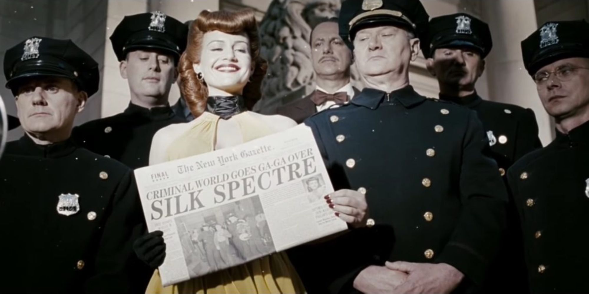 Superhero Silk Spectre flaunts a glamorous newspaper article for the press while surrounded by members of the police force.