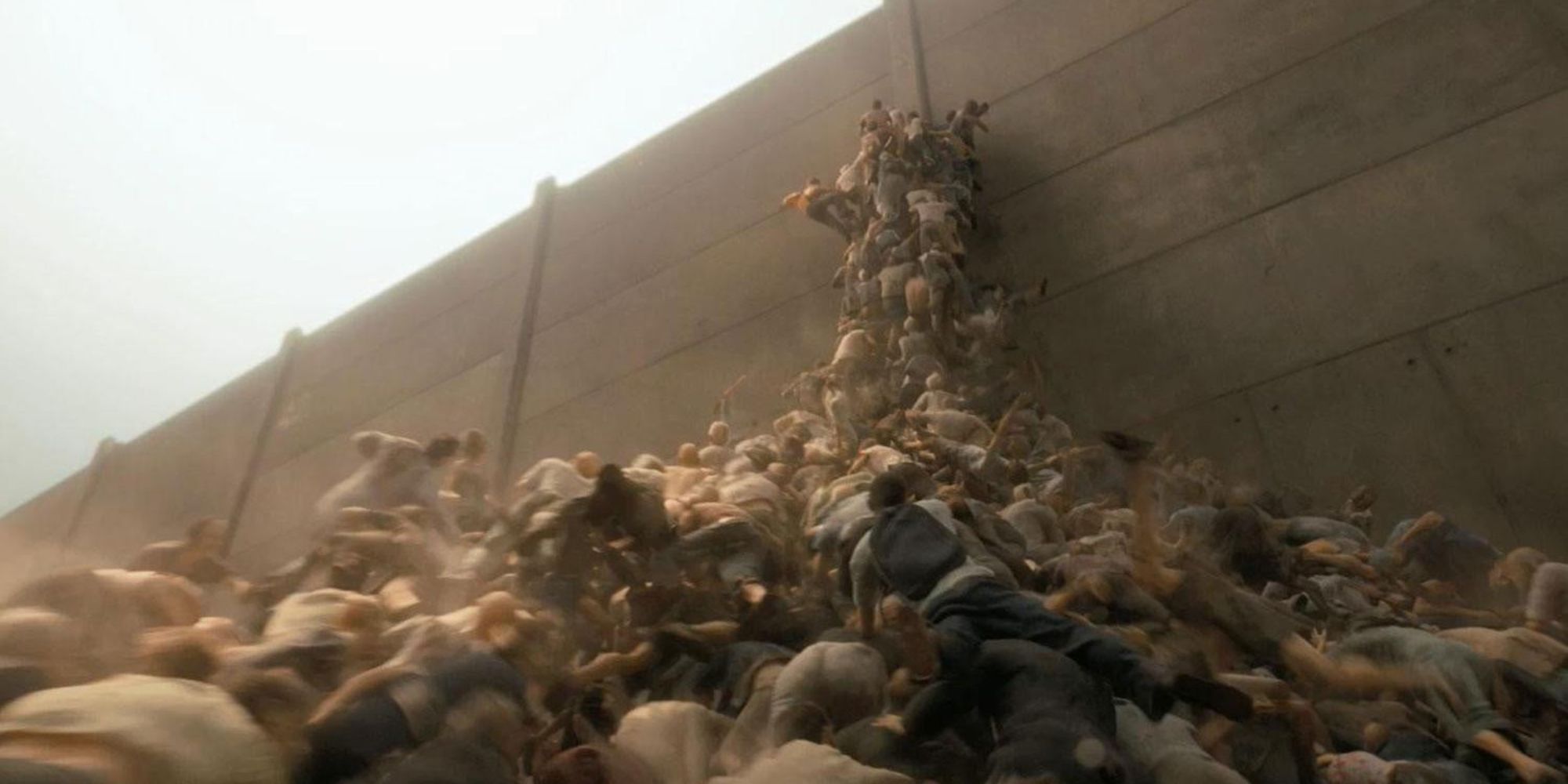 A horde of zombies climbs up the walls of fortified Israel in World War Z