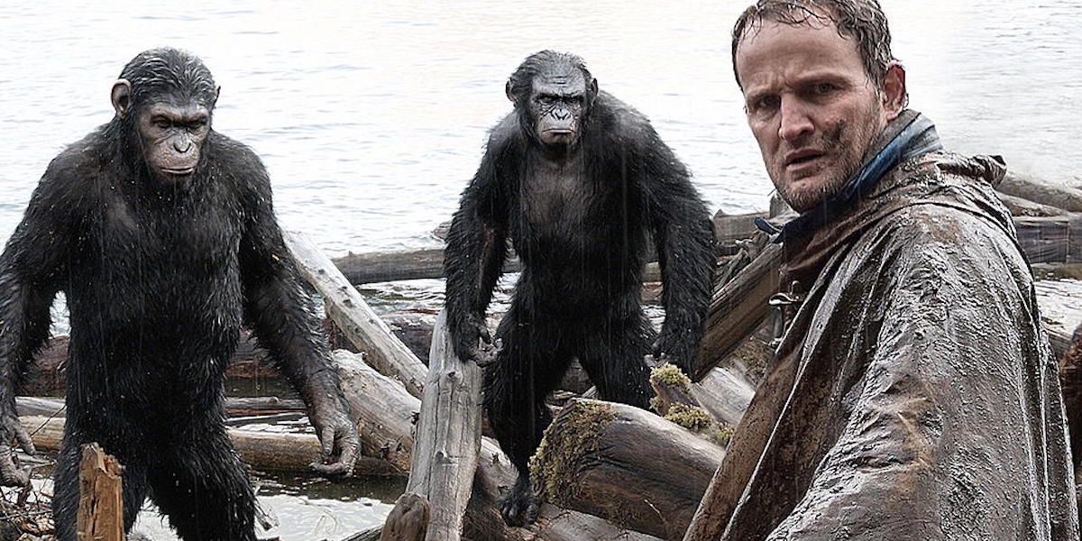 Jason Clarke as Malcolm opposite Caesar and Koba in Dawn of the Planet of the Apes.