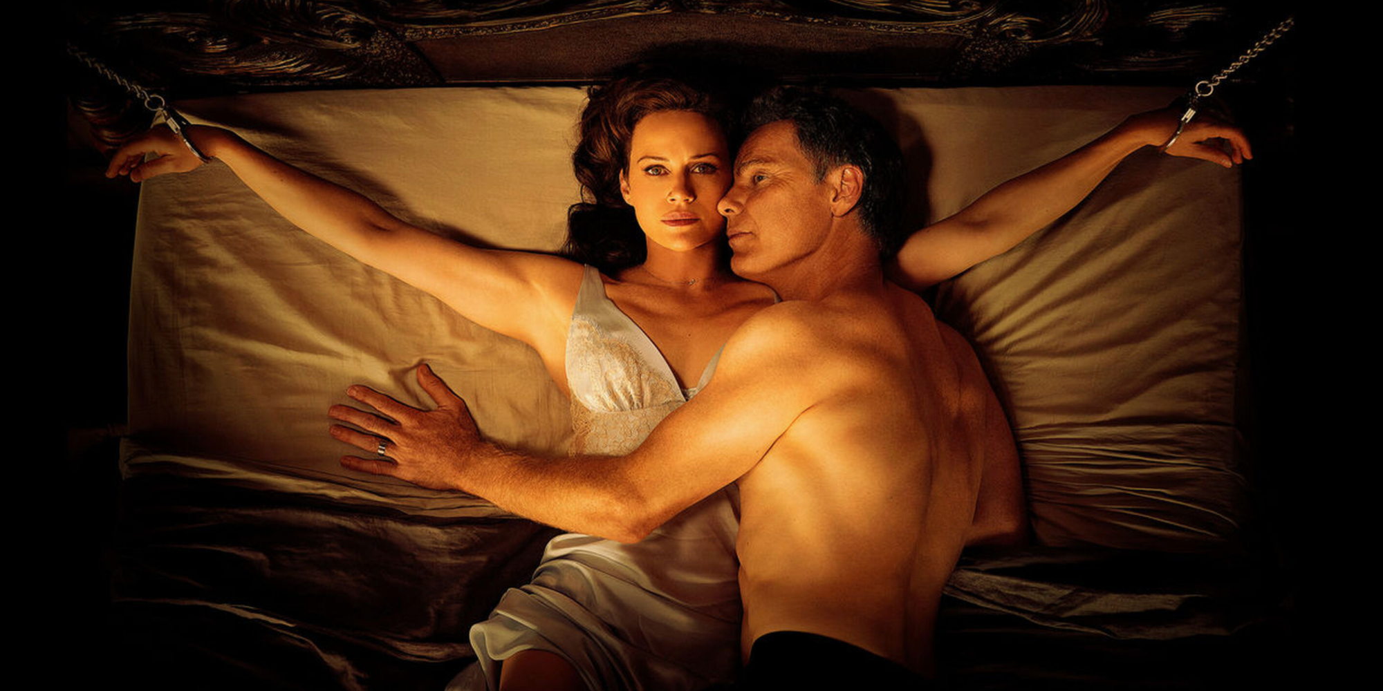 Jessie (Carla Gugino) and Gerlad (Bruce Greenwood) sleeping on a bed in 'Gerald's Game'