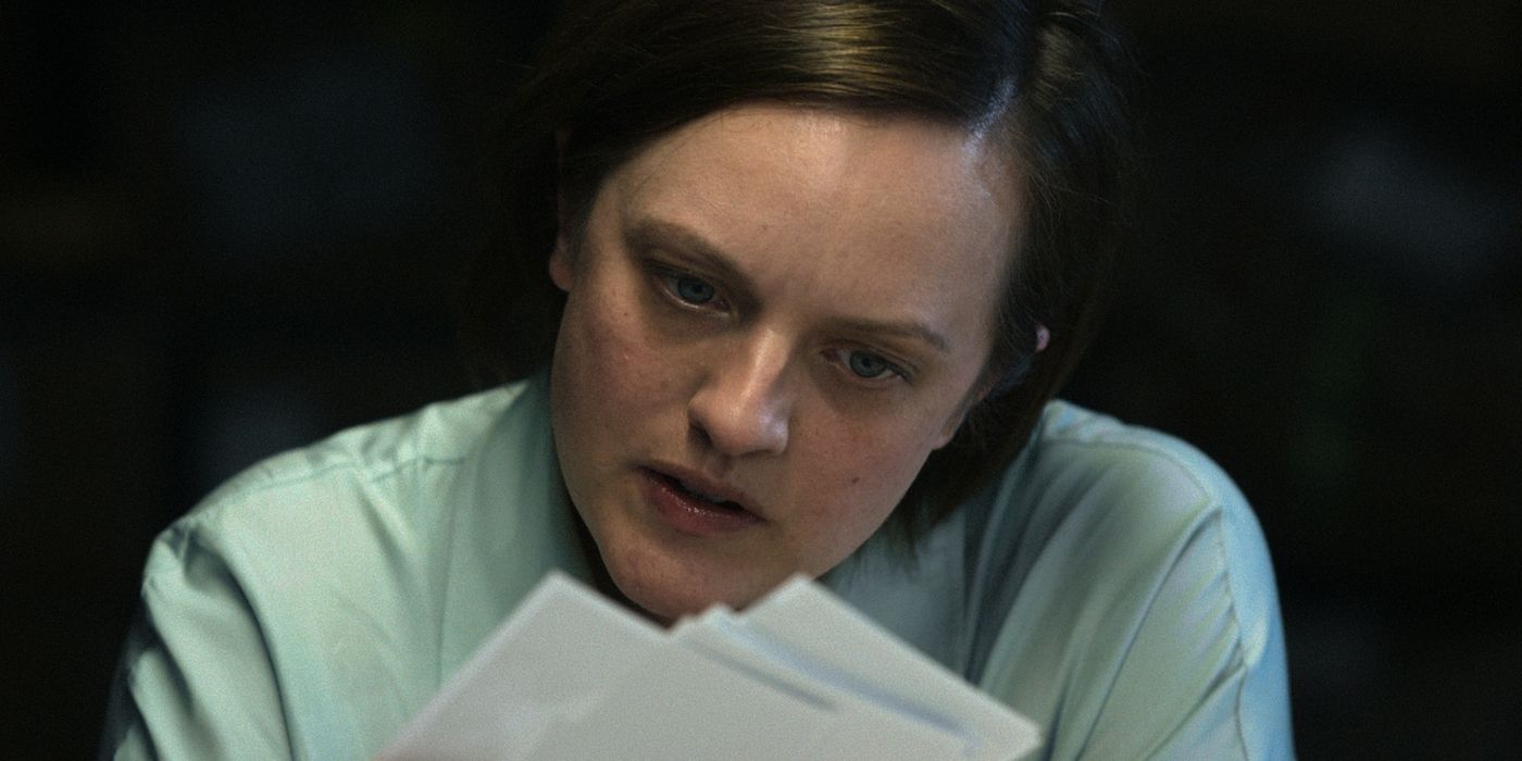 Elizabeth Moss looking at papers in Shining Girls