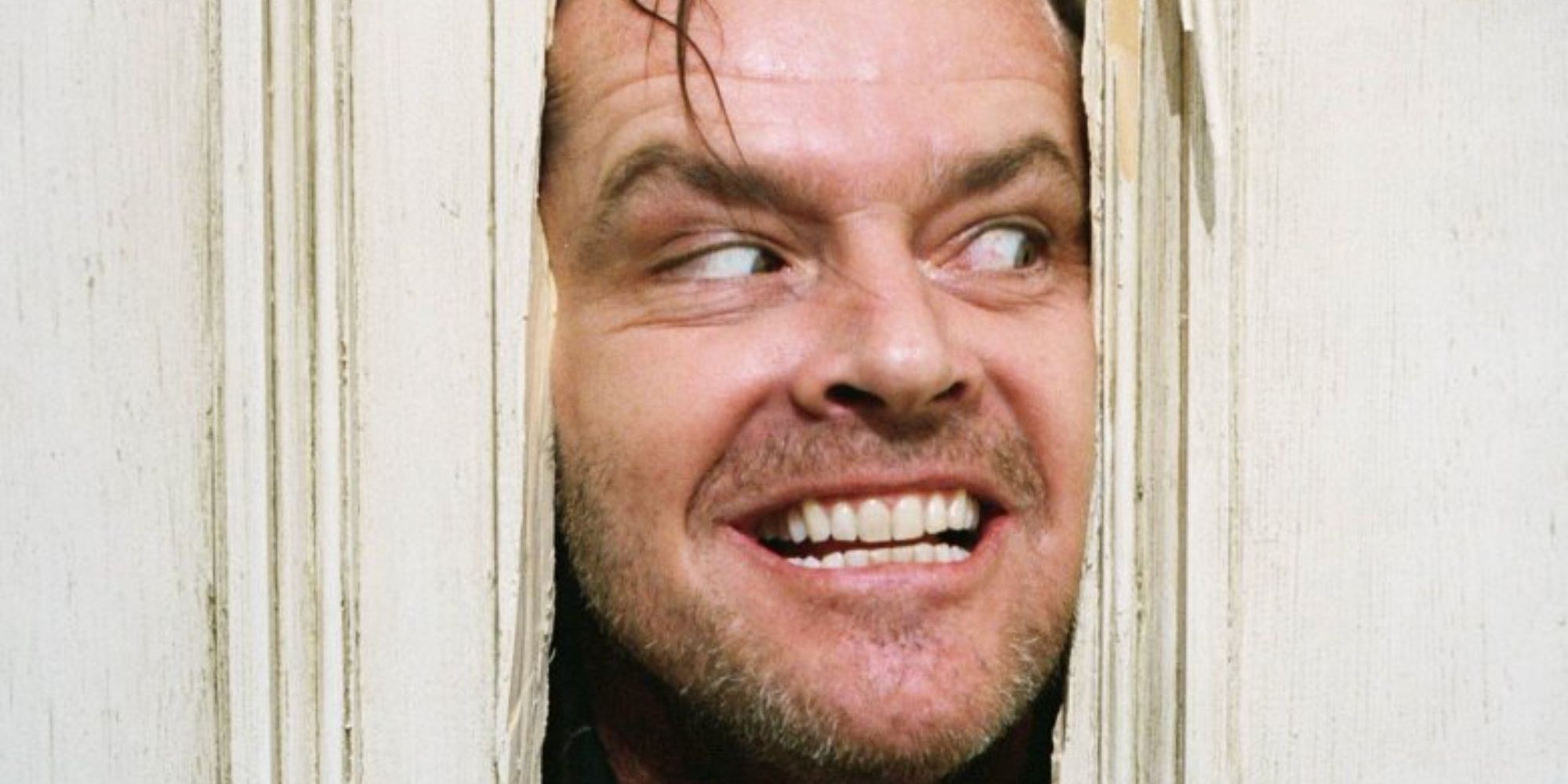 Jack Nicholson with head in door as Jack Torrence in 'The Shining'