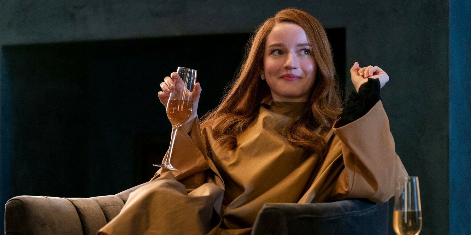 Julia Garner as Anna Delvey enjoys a glass of champagne