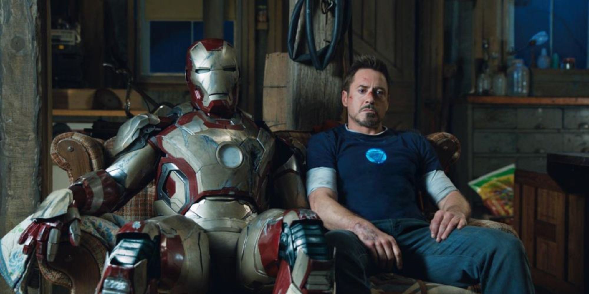 Tony Stark sitting on couch with malfunctioned suit