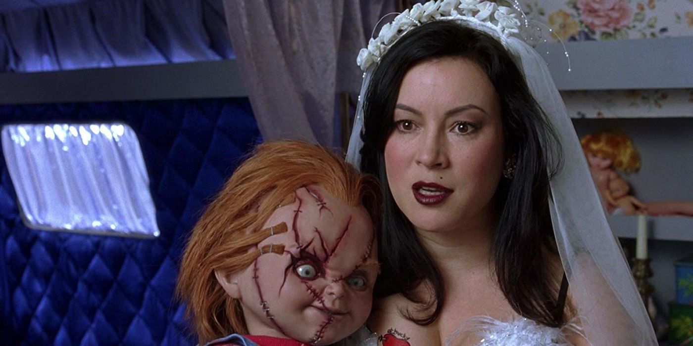 Jennifer Tilly as Tiffany Valentine in a wedding dress holding the Chucky doll in Bride of Chucky