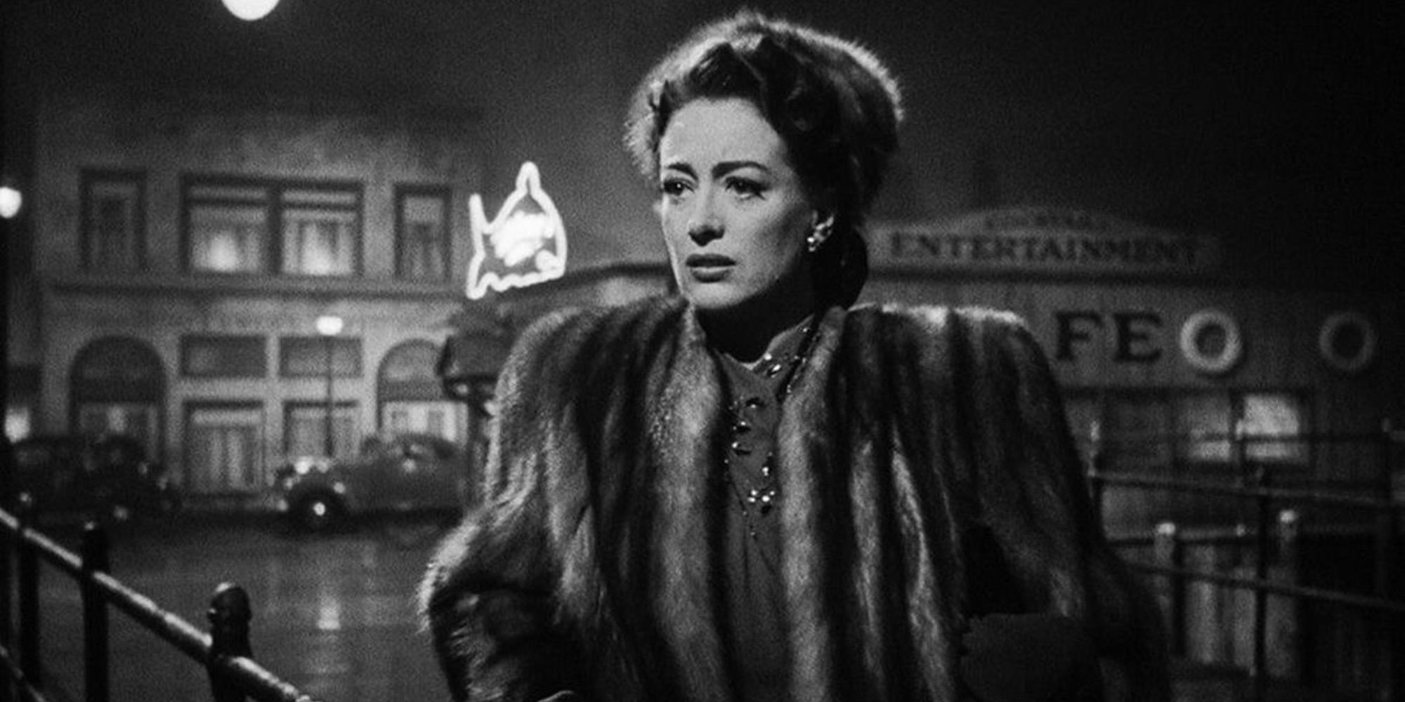 Joan Crawford as Mildred Pierce crying while standing on the street in Mildred Pierce.