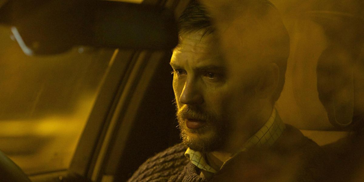 A man sits in his car looking stressed