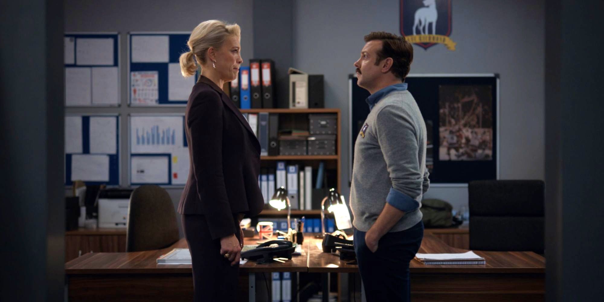 Jason Sudeikis as Ted Lasso and Hannah Waddingham as Rebecca Welton talking in 