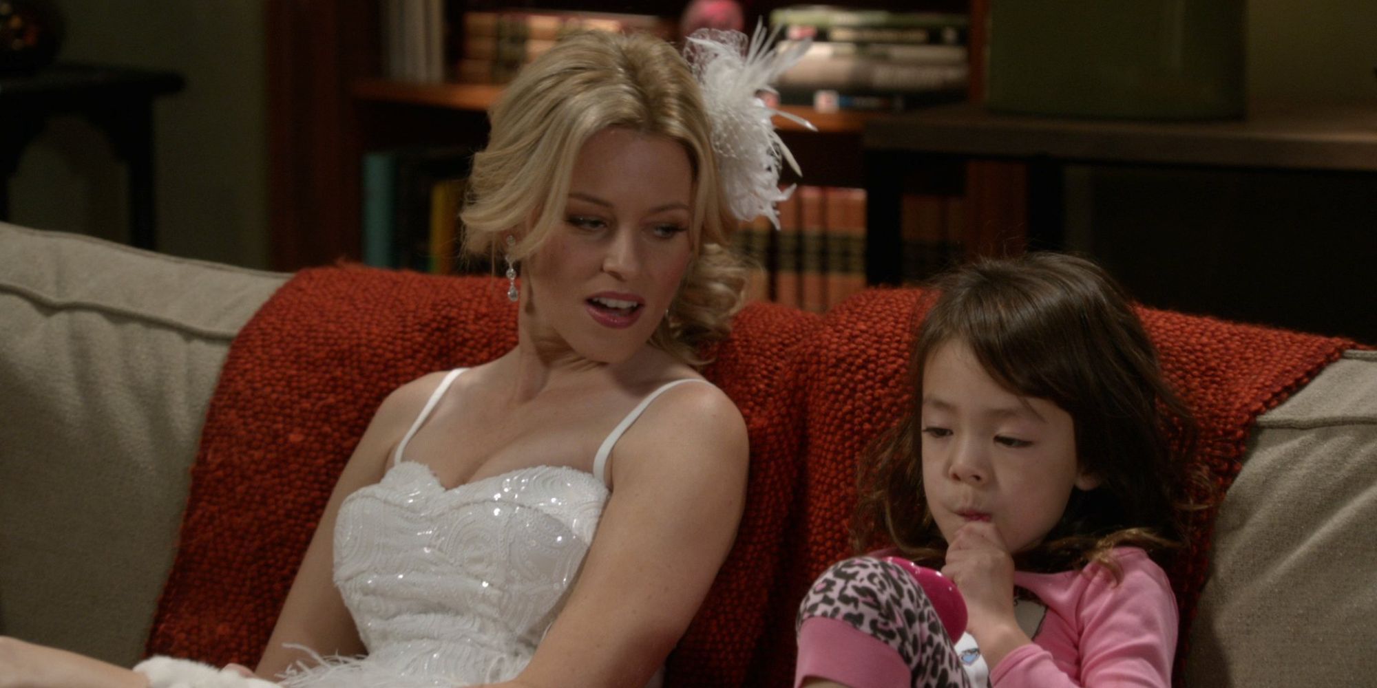 still of sal in a wedding dress talking to lily on the couch - modern family (Courtesy ABC)