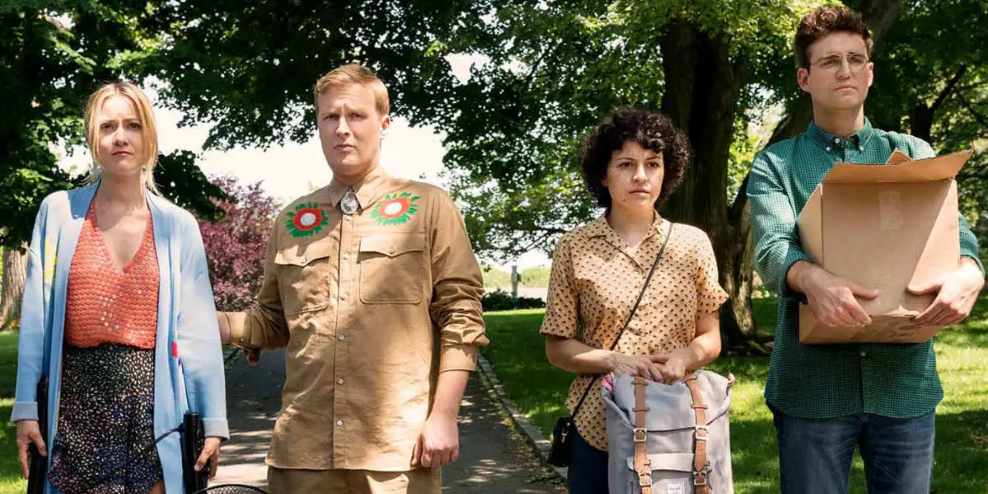 Four characters from Search Party standing outside, looking at something.