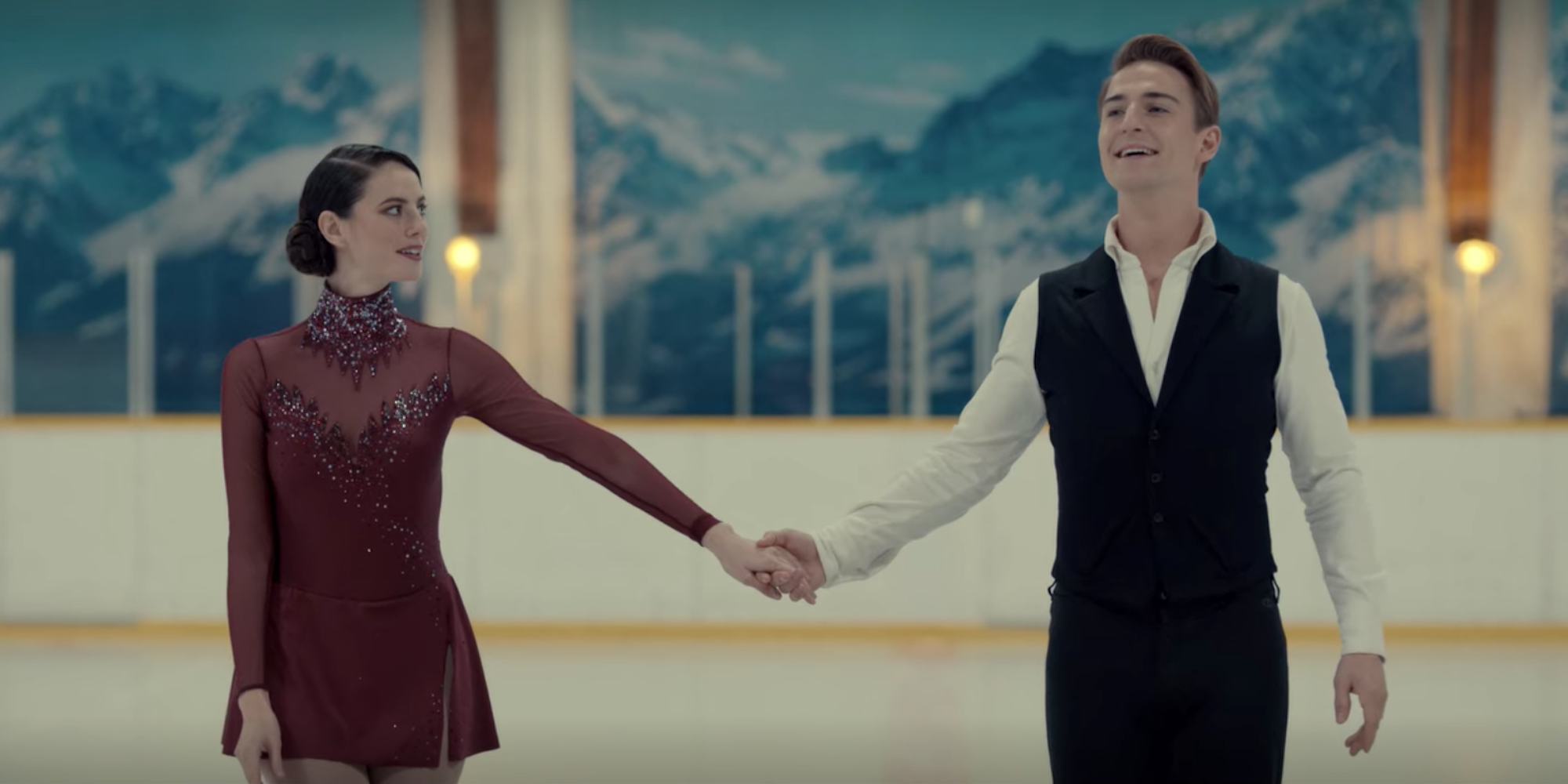 Kaya Scodelario as Kat Baker and Evan Roderick as Justin Davis dressed in performance attire at an ice rink in Spinning Out.