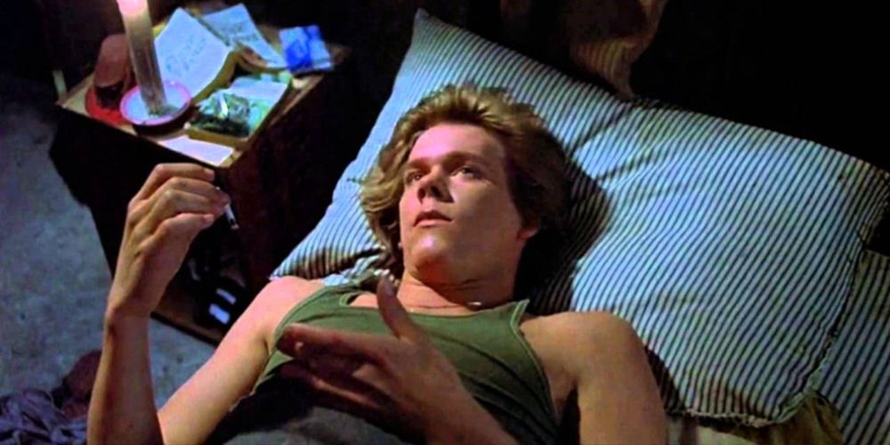 Kevin Bacon laying on a bed in Friday the 13th