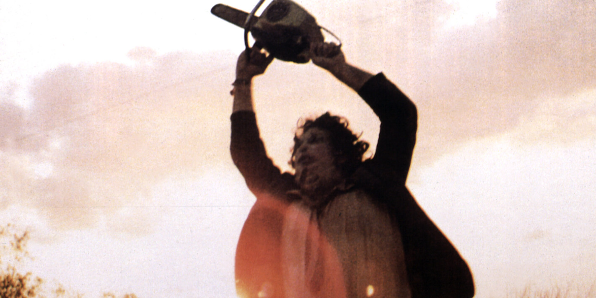 texas chainsaw massacre leatherface spins around with his chainsaw in the road