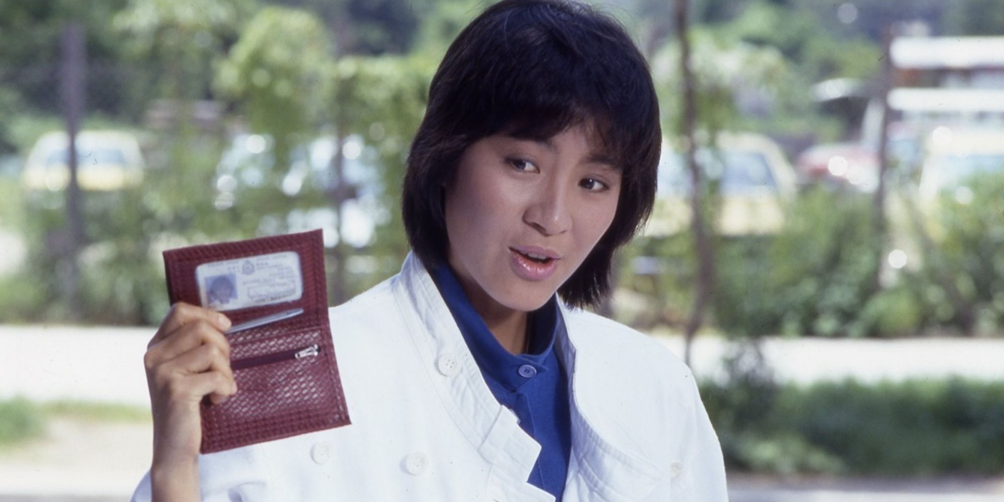 An officer is showing her badge