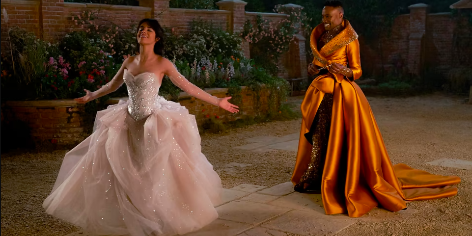Camilla Cabello in a ballgown, Billy Porter as fairy godmother happily looks on.