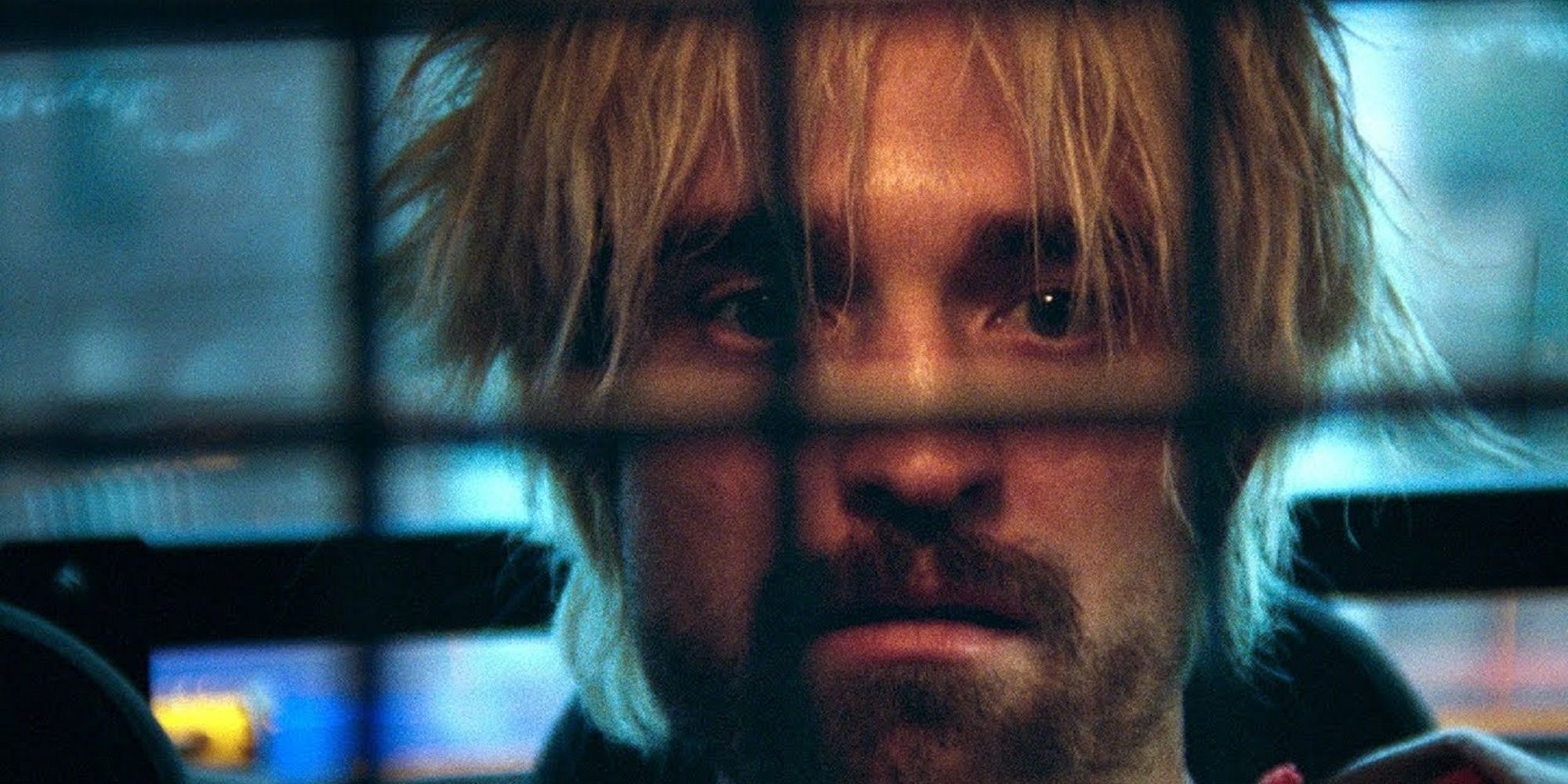 Robert Pattinson in the back of a cop car as Connie Nikas in Good Time.