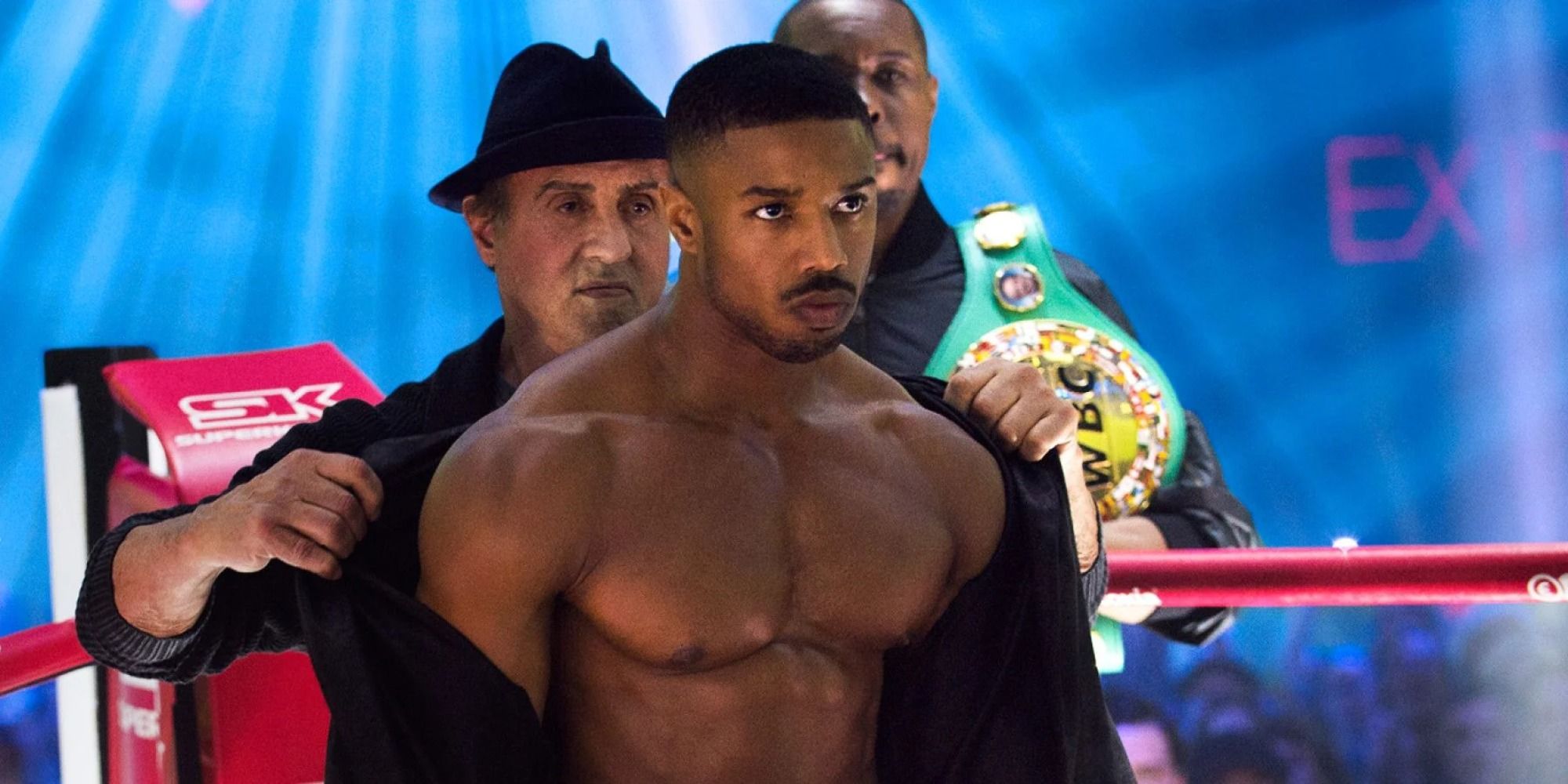 Rocky Balboa taking off Adonis Creed's robe before the fight in the ring