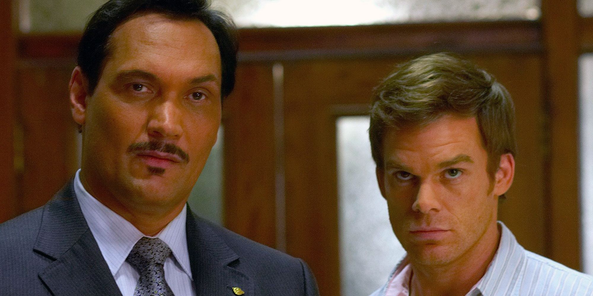 Miguel and Dexter stand next to one another in Dexter.