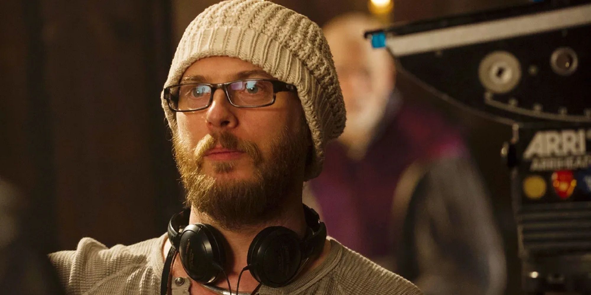 Duncan Jones with headphones on set directing film.