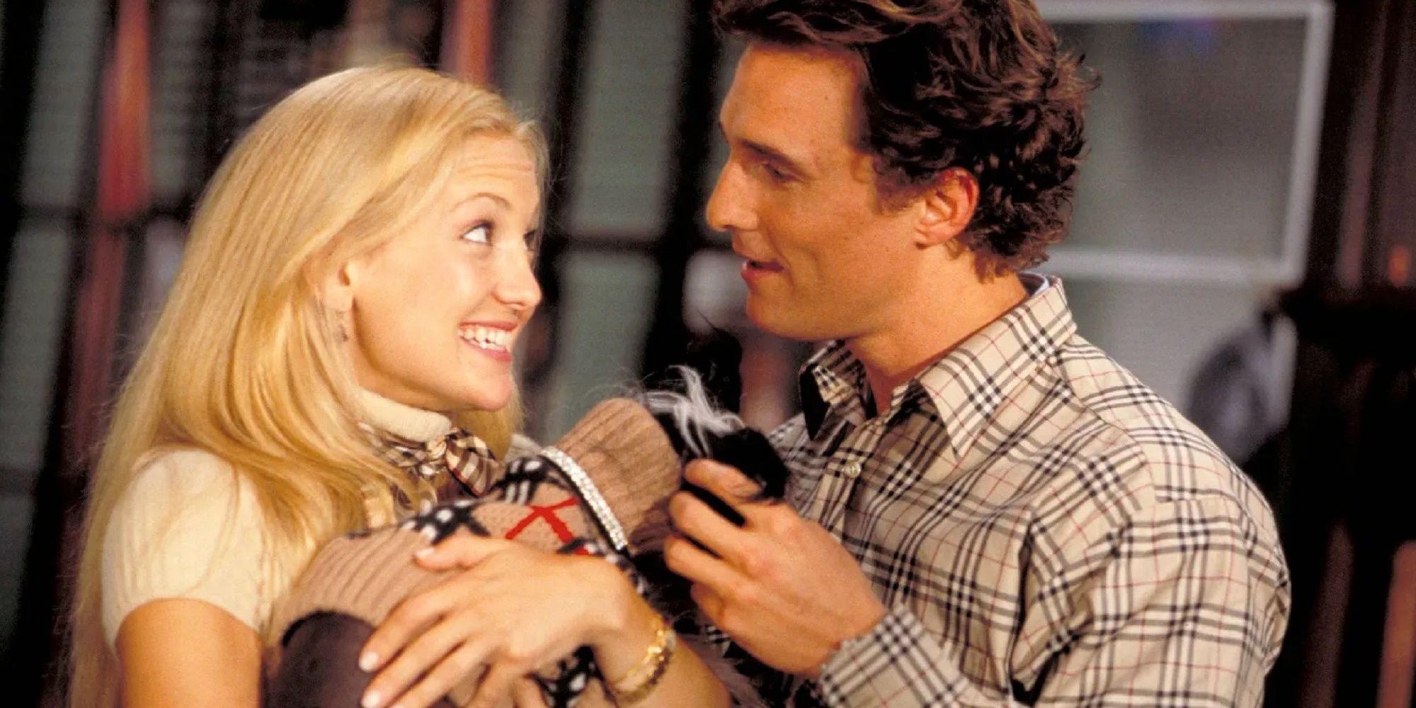 Kate Hudson and Matthew McConaughey holding dog.
