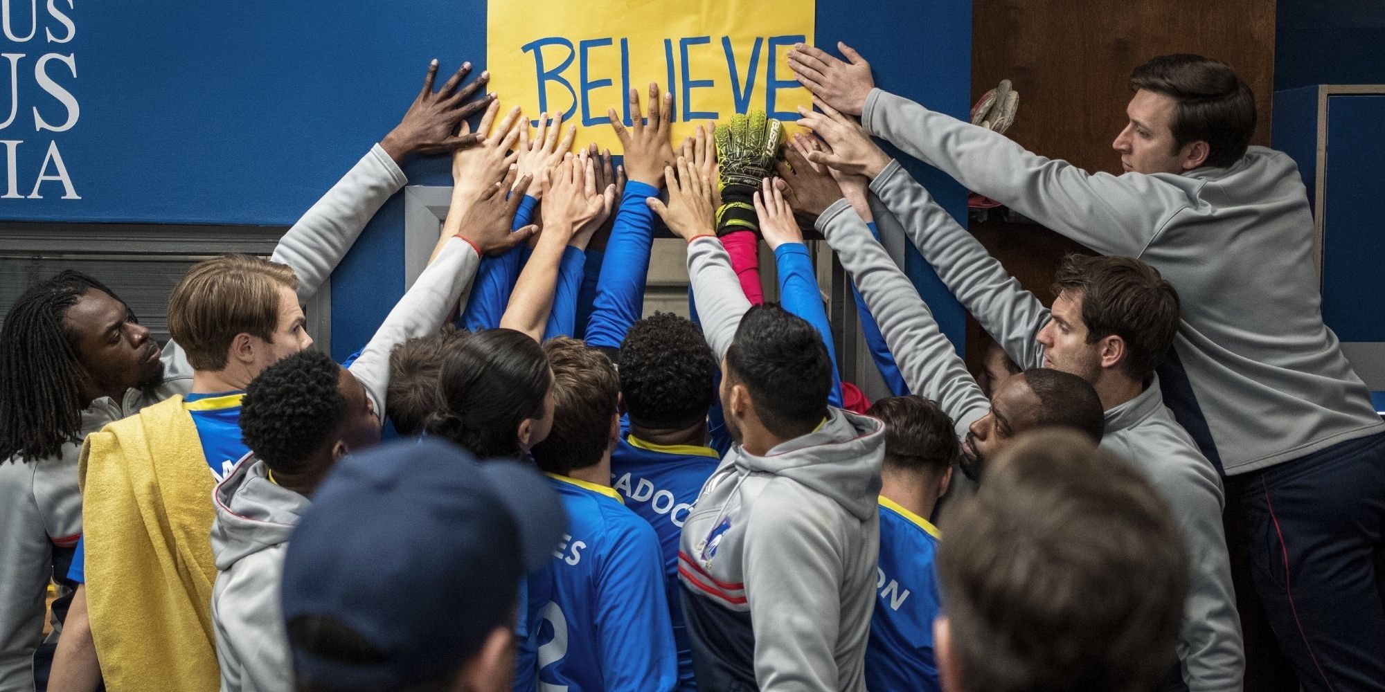AFC Richmond touching "Believe" sign