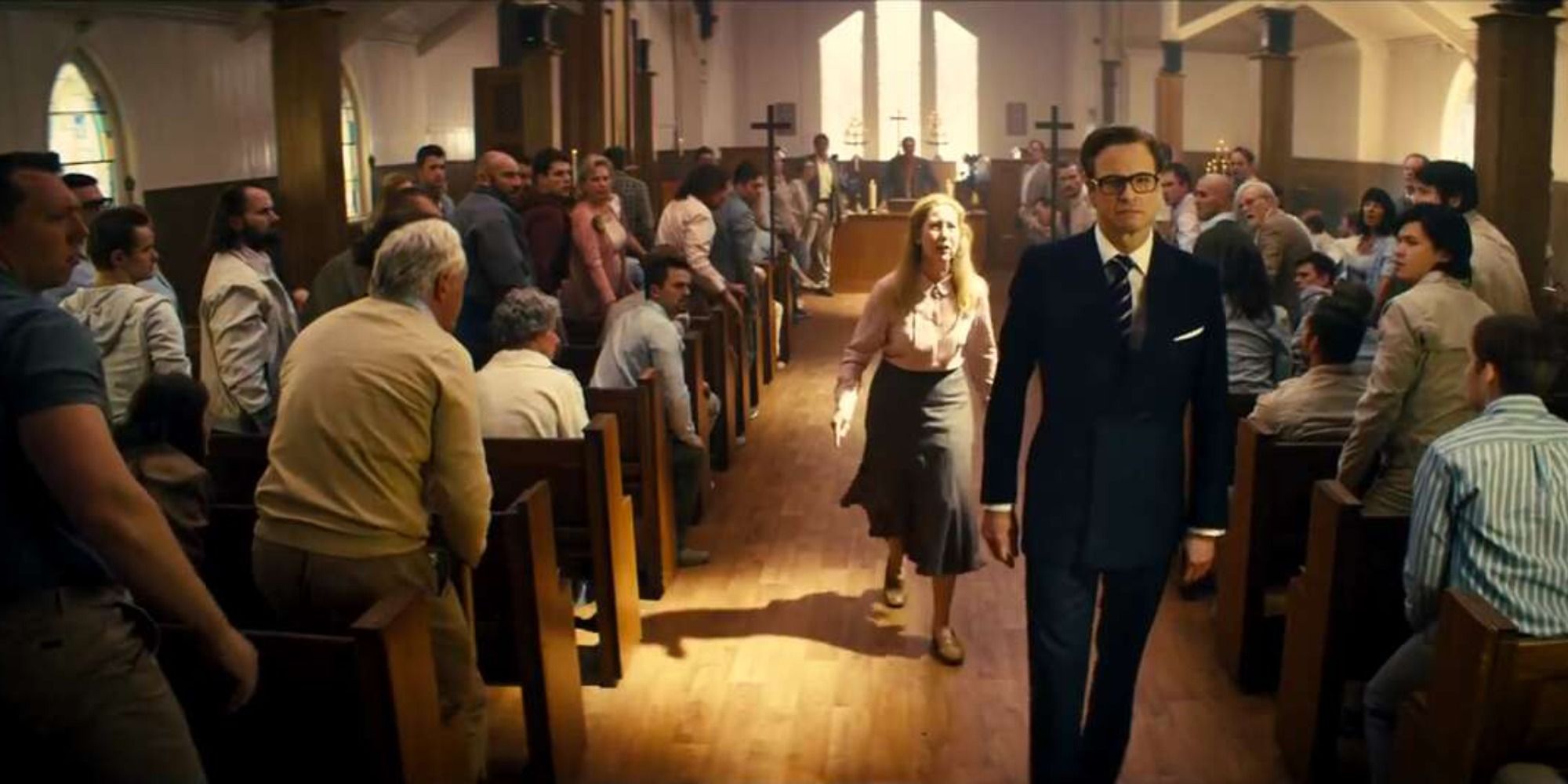 Colin Firth about to leave a church filled with people 