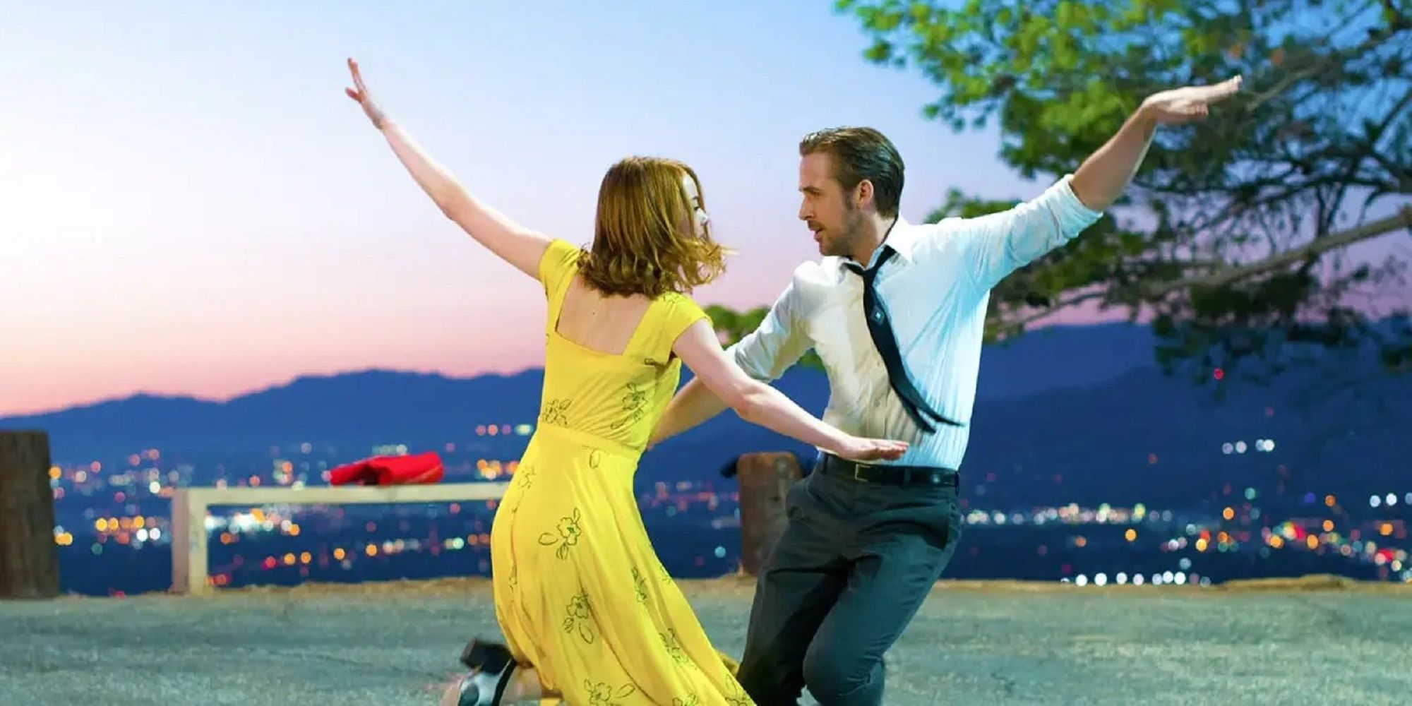 Emma Stone and Ryan Gosling dancing at night.
