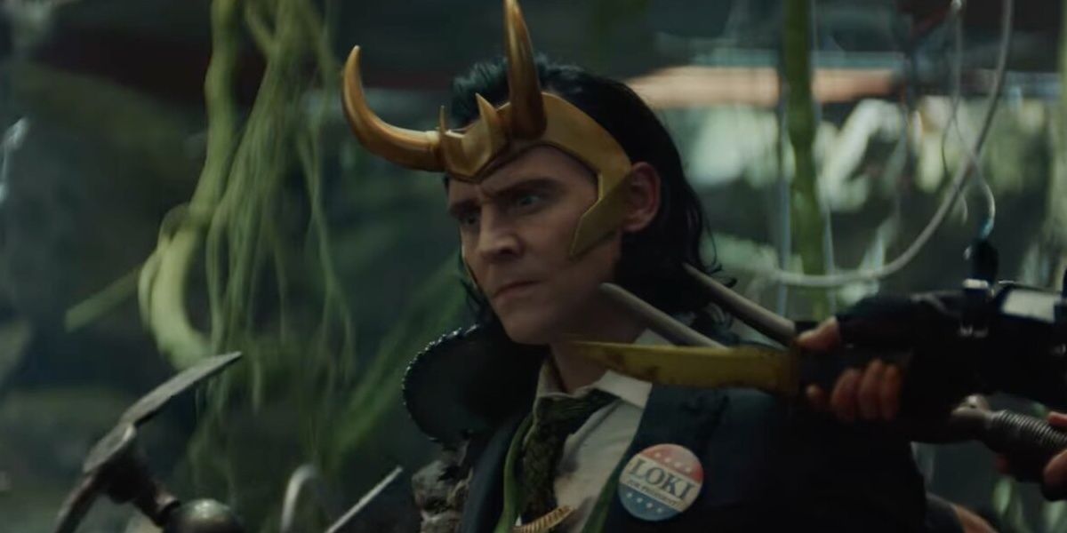 Tom Hiddleston as a Loki variant who wears a presidential Loki button. A hand holds a pitch fork towards Lokis face.