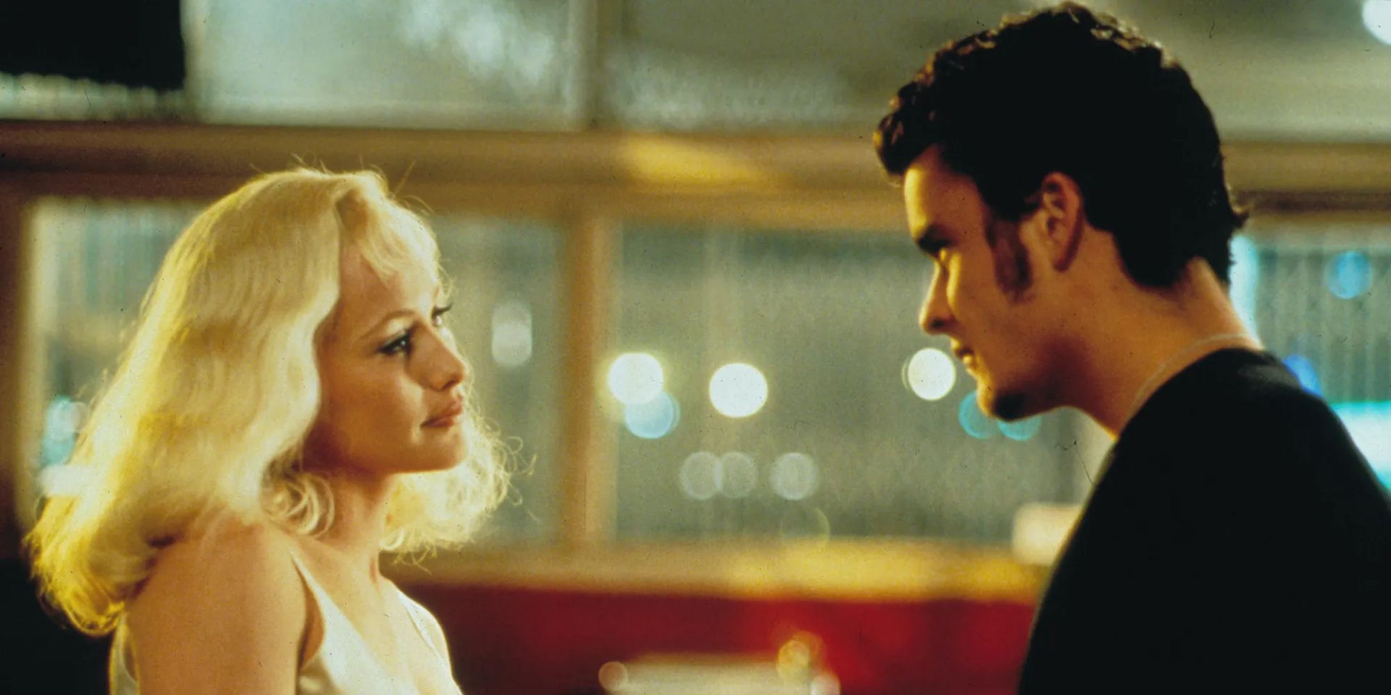 a man and a woman stare at each other in a diner