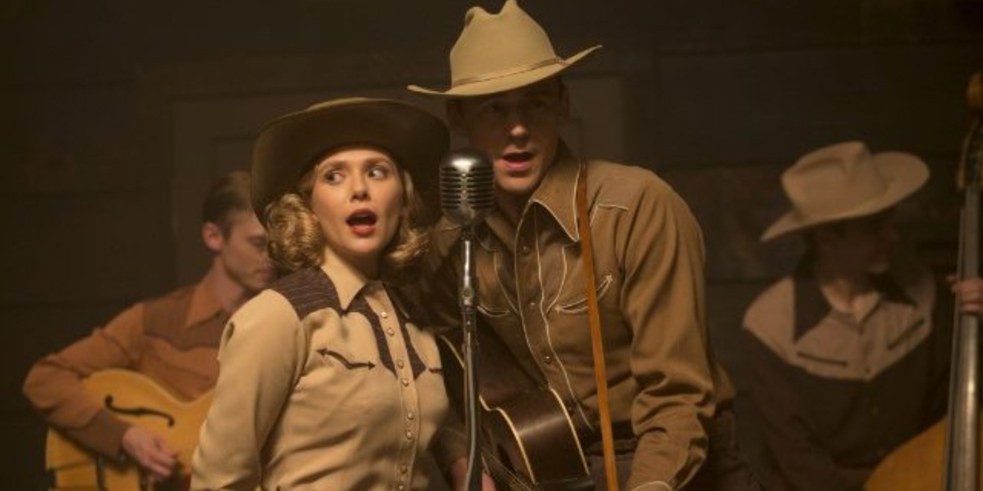 A couple in cowboy outfit sing on the stage 