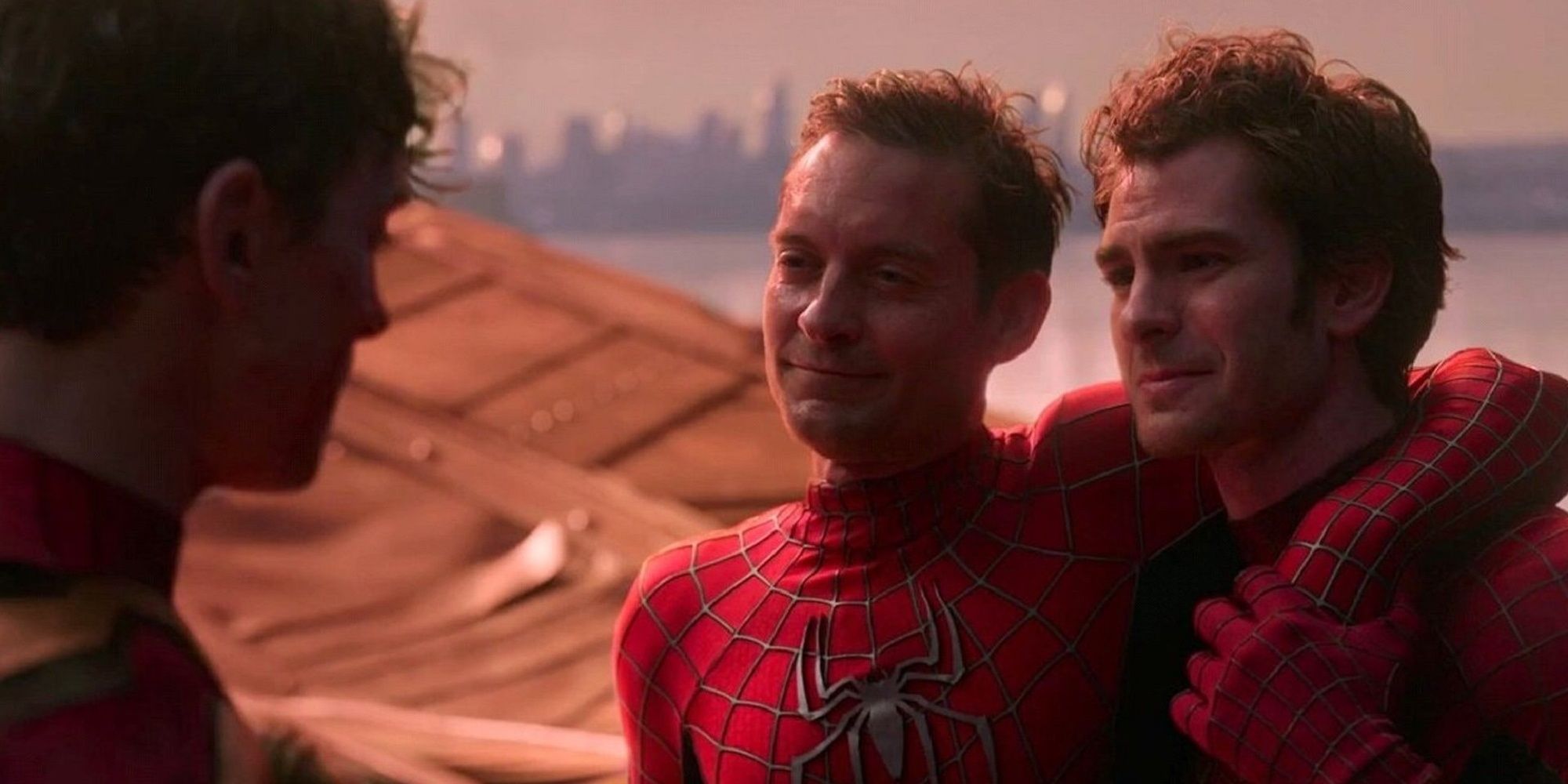 Tobey Maguire and Andrew Garfield as Peter 2 and Peter 3 hugging while talking to Peter 1 in Spider-Man: No Way Home