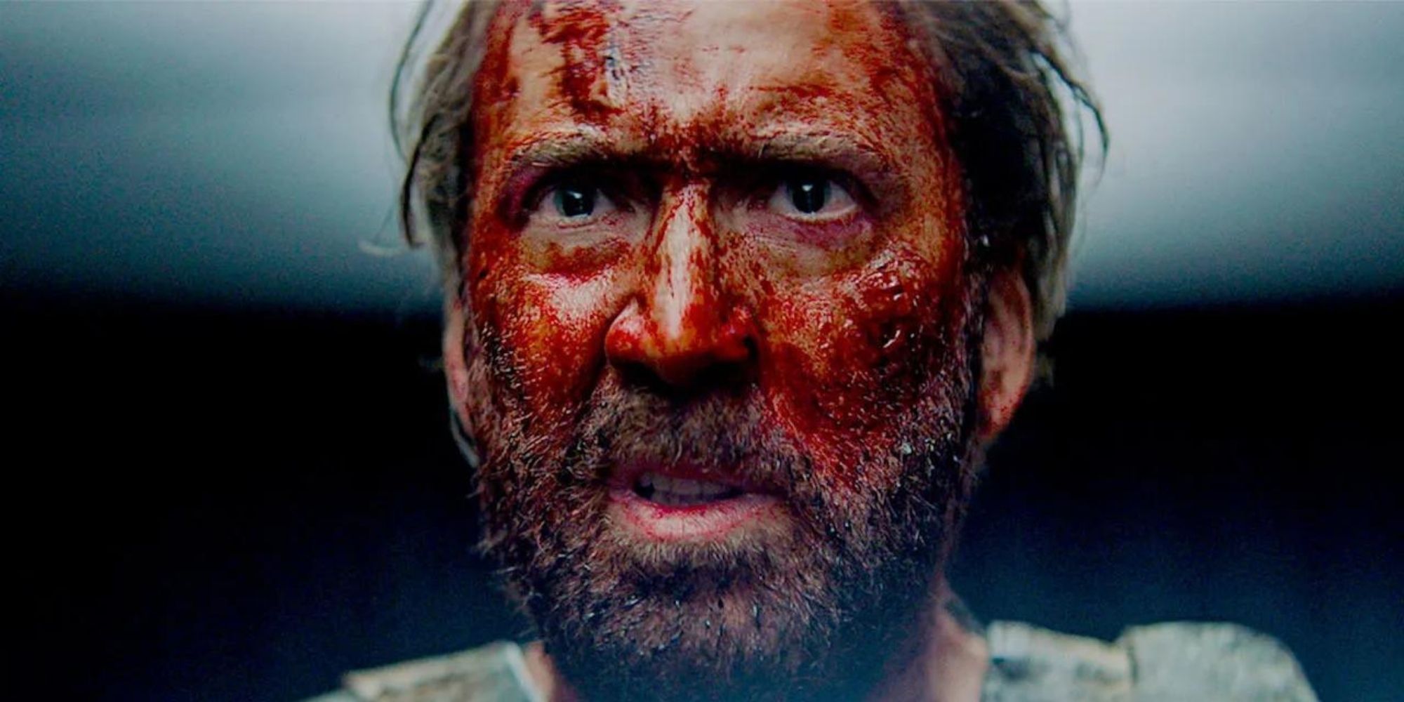 Nicolas Cage in Mandy with blood soaked face and angry