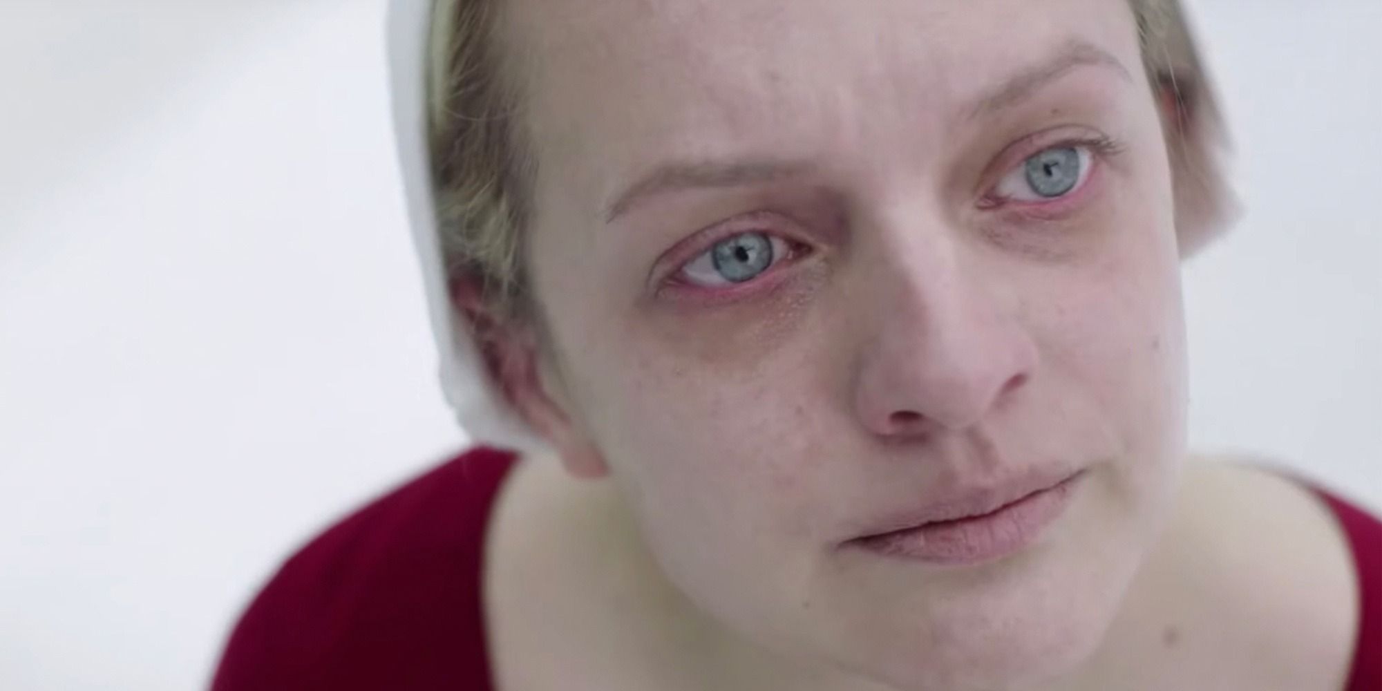 Offred staring with tears in her eyes