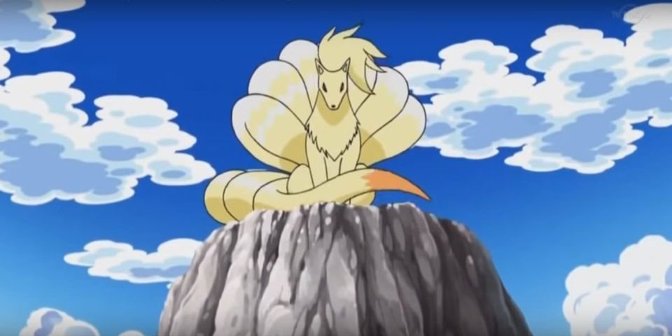 White fox Ninetales sits on a mountain top in Pokemon.