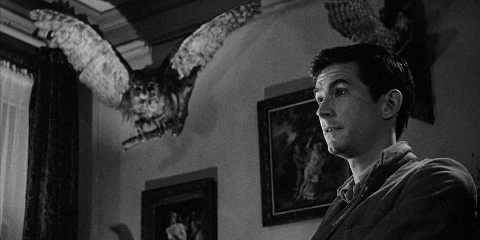 Psycho - Norman Bates standing below an eagle statue